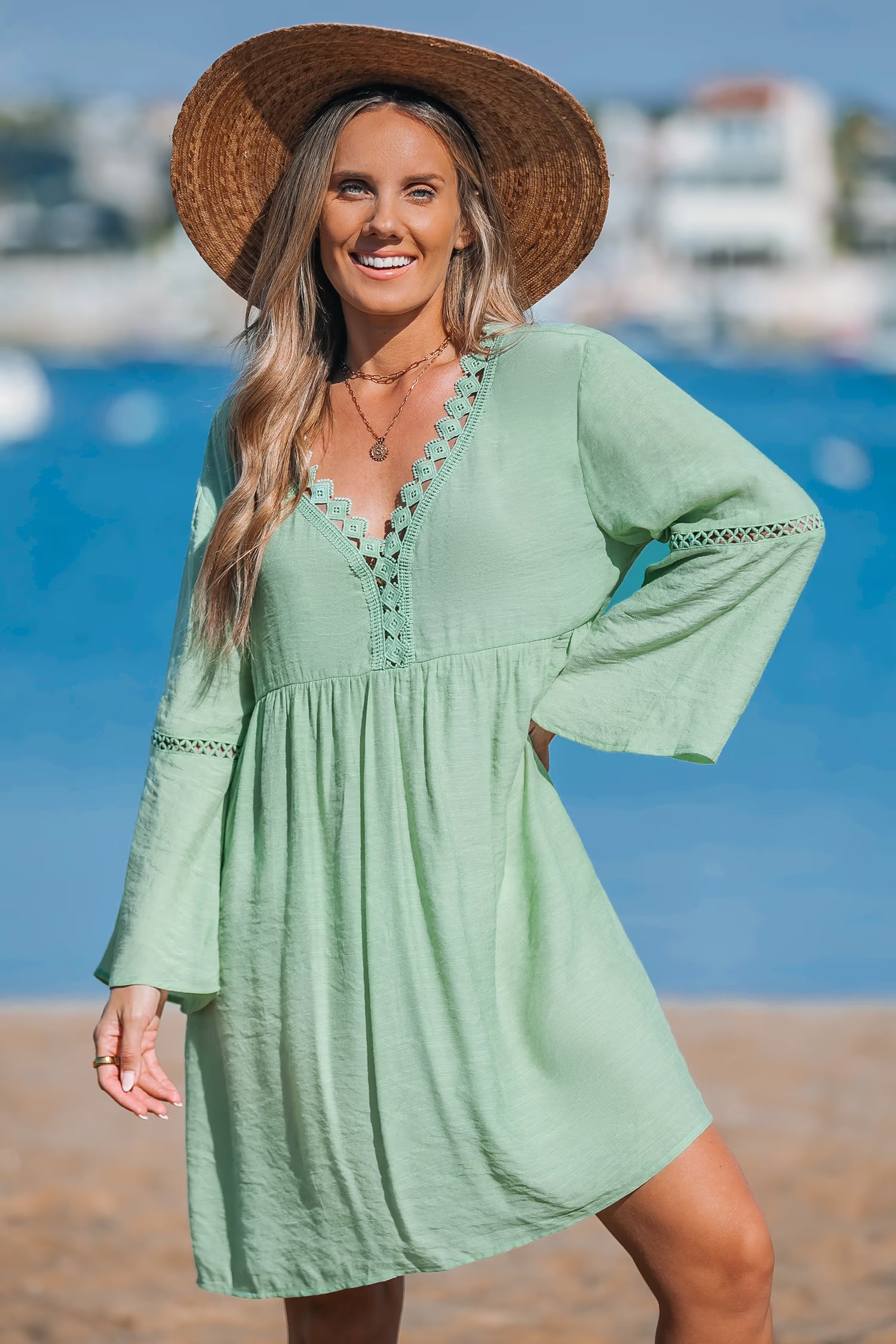 Short green dress with V-neck.