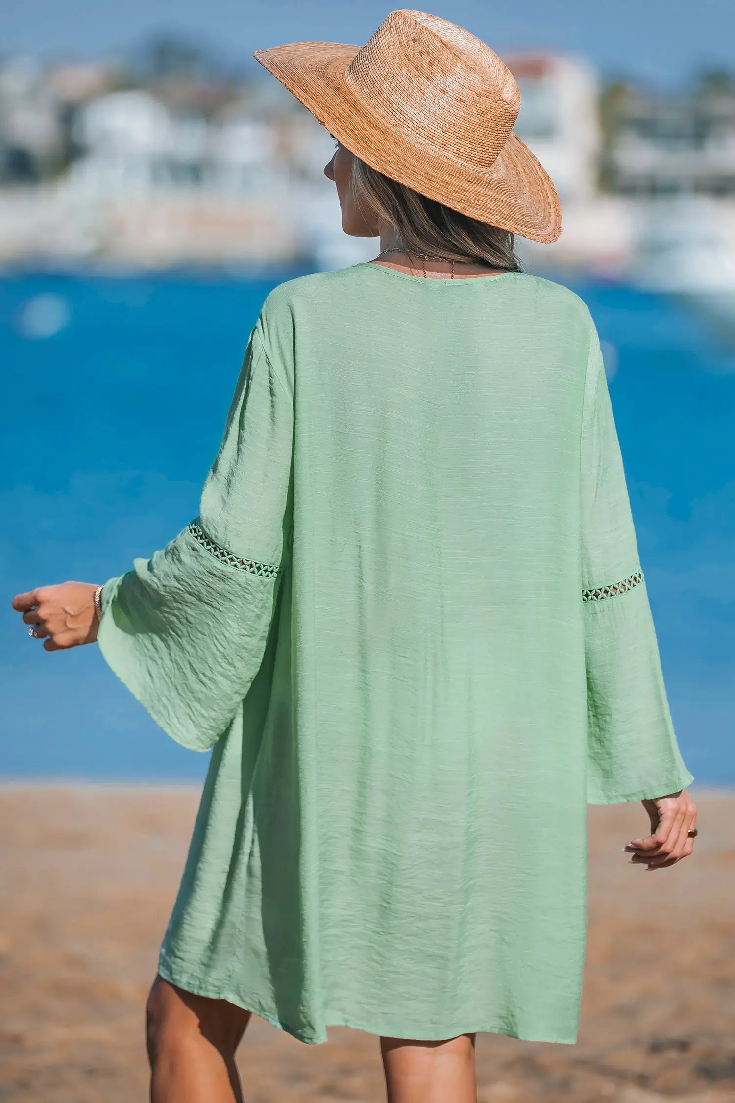 Short green dress with V-neck.